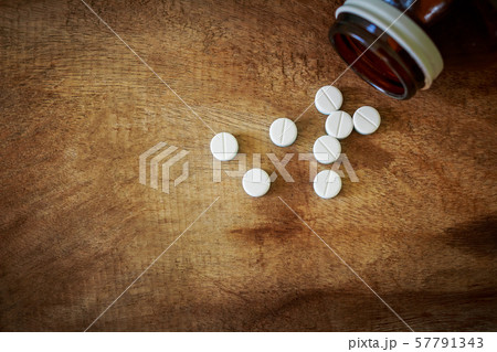Paracetamol on the old wooden floor 57791343