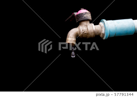 old rusty tap leaking water isolate on black 57791344