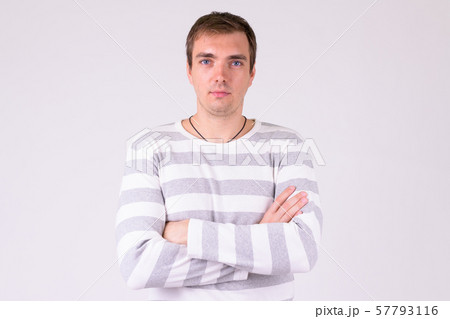 Portrait of man with arms crossed against white background 57793116