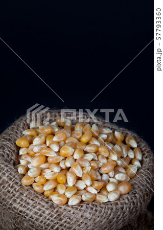 The dry corn kernels on hemp sack with black space 57793360