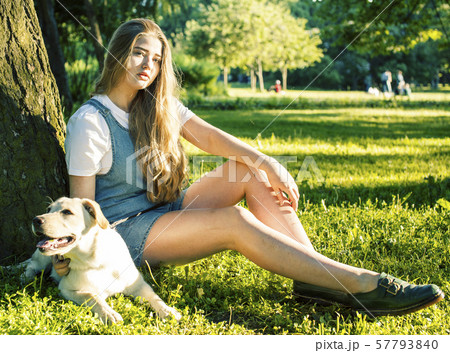 young attractive blond woman playing with her dog in green park at summer, lifestyle people concept young attractive blond woman playing with her dog in green park at summer, lifestyle people concept 57793840