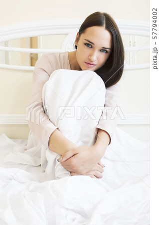 young pretty brunette woman laying in bed alone waiting sexy, lifestyle people concept 57794002