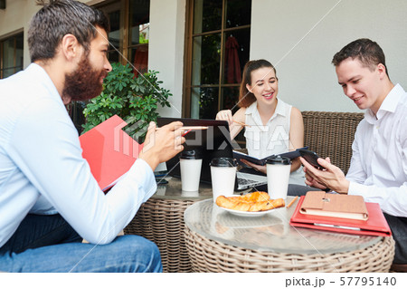 Smiling entrepreneur checking smartphone 57795140