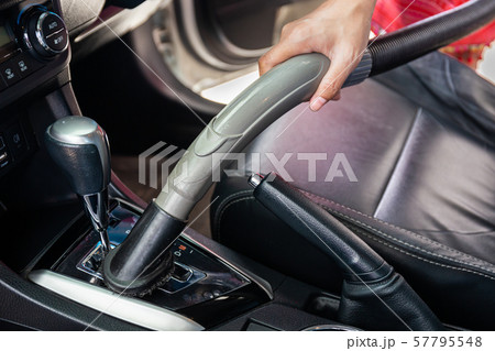 Cleaning modern car interior with vacuum cleaner. Handle vacuum 57795548