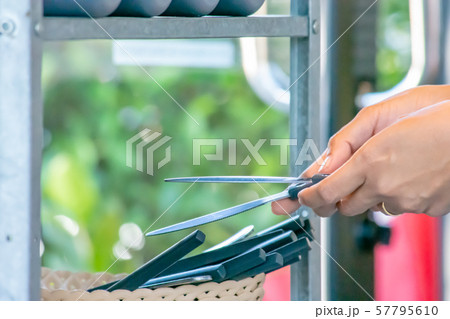 The hand holding the steak knives and knife cut a lot in the basket. 57795610