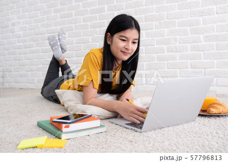 Asian female freelancer working on laptop computer 57796813