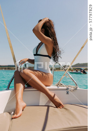 beautiful girl with dark hair in luxurious bikini relaxing on yacht beautiful girl with dark hair in luxurious bikini relaxing on yacht 57797829