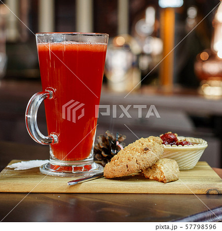 Delicious red cocktail with a sweet dessert Delicious red cocktail with a sweet dessert 57798596