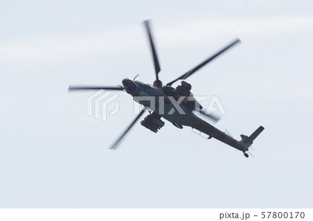 A military helicopter with red stars on the the bottom panel flying in the white sky A military helicopter with red stars on the the bottom panel flying in the white sky 57800170