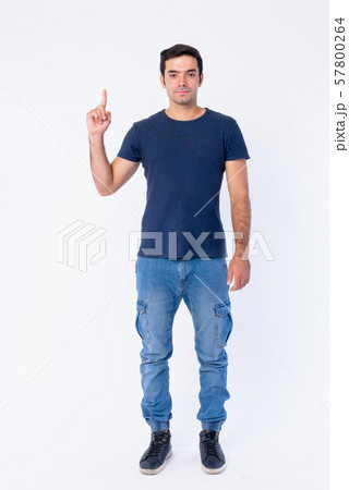 Full body shot of young handsome Persian man pointing up 57800264