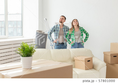 Family, new apartment and relocation concept - Young couple moving in new house Family, new apartment and relocation concept - Young couple moving in new house 57801000