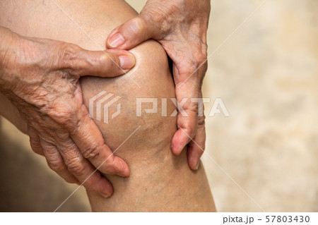 Senior woman suffering from knee pain sitting on chair, Massaging by her hand, Close up, Body concept 57803430