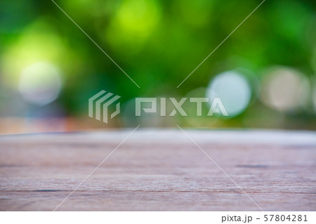 Empty curved wooden table texture, Green garden blurred bokeh background, Selective focus 57804281