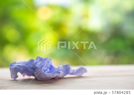 Crumpled white paper on wood table, Bokeh green garden background, Close up & Macro shot, Selective focus, Brainstorming, Creative idea, Business concept Crumpled white paper on wood table, Bokeh green garden background, Close up & Macro shot, Selective focus, Brainstorming, Creative idea, Business concept 57804285