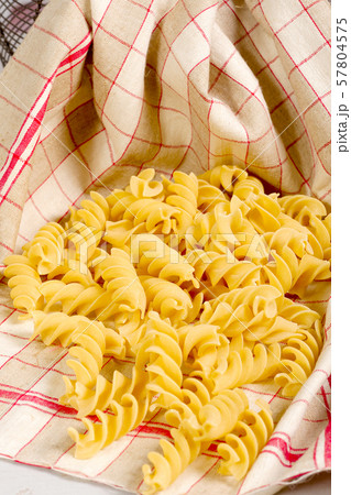 Pasta in a towel on a wooden table 57804575