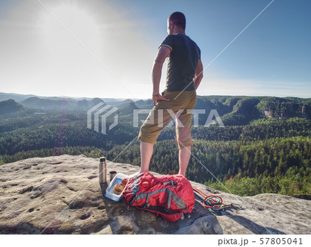 Hiker enjoy Refreshment. Tourist staying on top of Hiker enjoy Refreshment. Tourist staying on top of 57805041