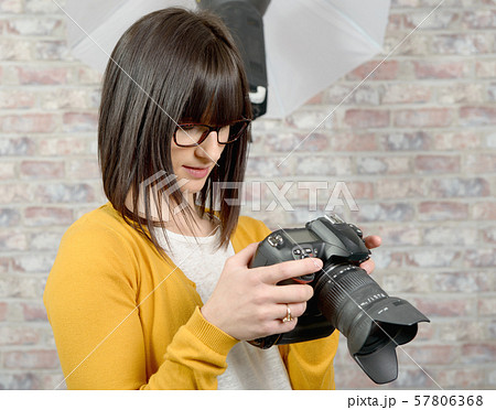Attractive brunette woman with photo camera 57806368