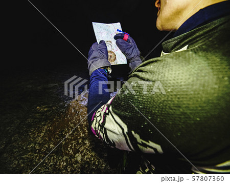Night race runner in black yellow red jersey hold 57807360