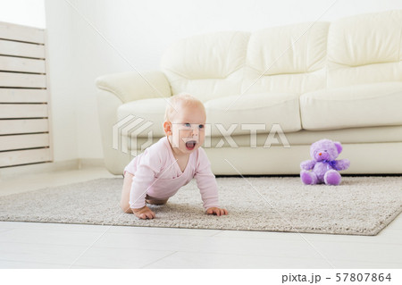 beautiful smiling baby crawling for the first time. 57807864