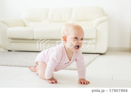 Smiling crawling baby girl at home on floor 57807866