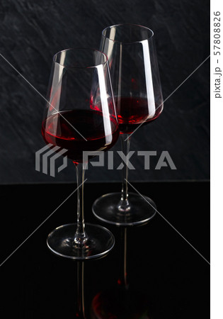 Bottle and glass of red wine on black background 57808826