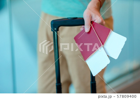 Closeup of man holding passports and boarding pass at airport 57809400
