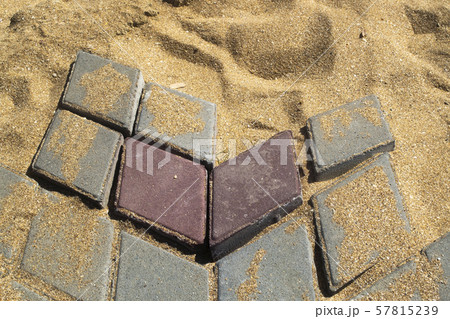 Destroyed path of paving stone on a sandy base 57815239