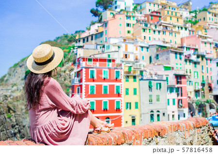 Young woman with great view at old village Riomaggiore, Cinque Terre, Liguria 57816458