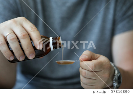 Man catching cold and taking medicine 57816890