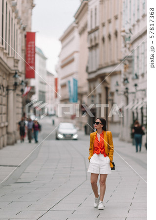 Woman walking in city. Young attractive tourist outdoors in italian city Woman walking in city. Young attractive tourist outdoors in italian city 57817368