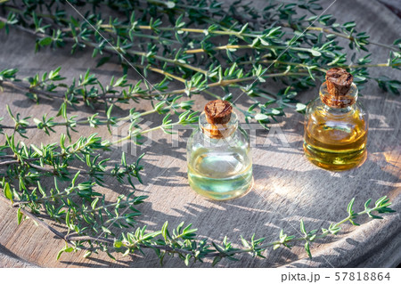 Bottles of thyme essential oil with fresh thyme 57818864