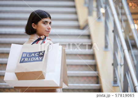 Young Woman Holding Shopping Bags on Black Friday 57819065