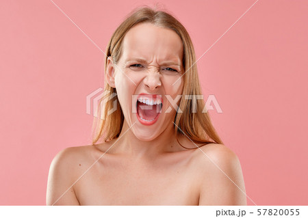 Beautiful girl screaming loud with mouth wide open 57820055