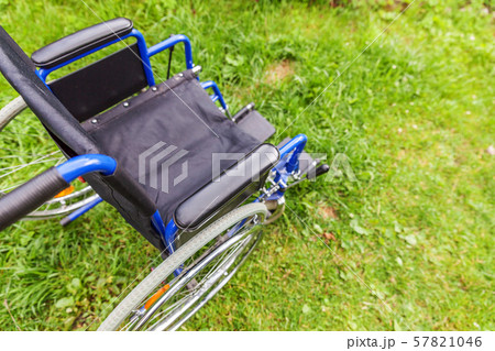 Empty wheelchair standing on grass in hospital Empty wheelchair standing on grass in hospital 57821046