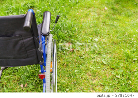 Empty wheelchair standing on grass in hospital Empty wheelchair standing on grass in hospital 57821047