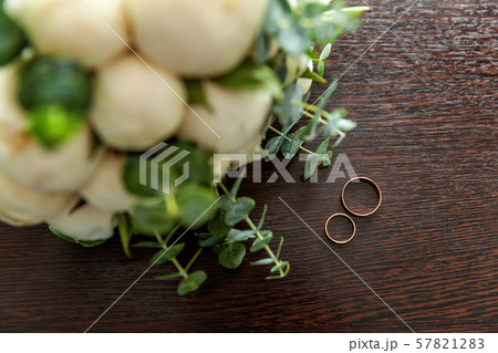 Wedding rings lie on wooden surface against Wedding rings lie on wooden surface against 57821283