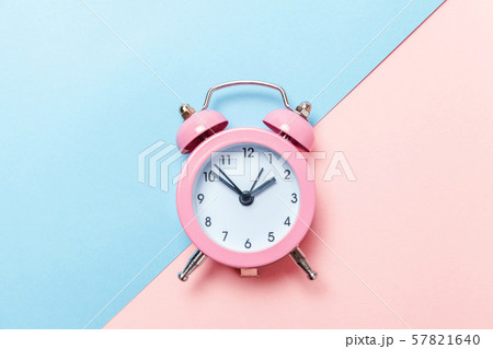 Vintage alarm clock Isolated on blue and pink 57821640