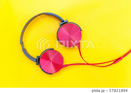 Red headphones with cable isolated on yellow Red headphones with cable isolated on yellow 57821894