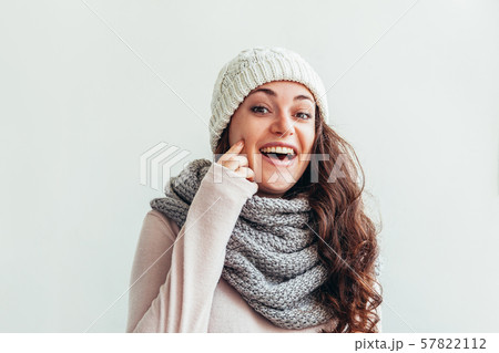 Laughing girl wearing warm clothes hat and scarf 57822112