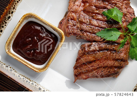 Steak on the bone with red sauce. restaurant menu Steak on the bone with red sauce. restaurant menu 57824643
