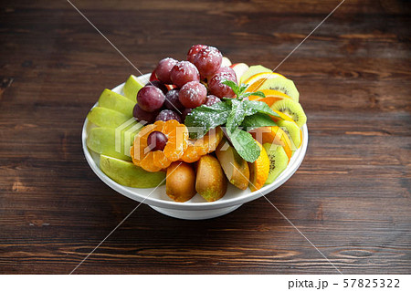 Sliced fruits on a white plate . catering menu Sliced fruits on a white plate . catering menu 57825322