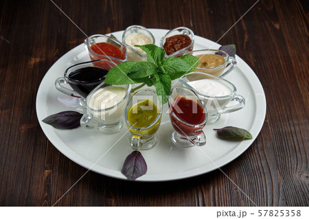 sauces in bowls on a dark wooden background. menu for catering sauces in bowls on a dark wooden background. menu for catering 57825358