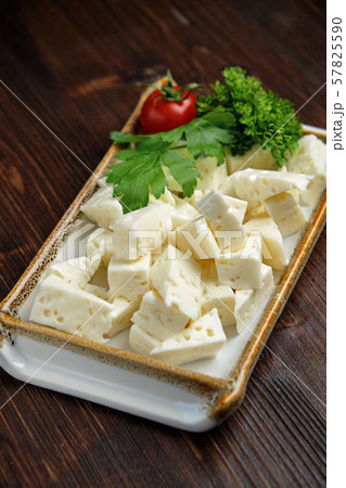 Cheese platter on a dark background. Food styling. Restaurant menu Cheese platter on a dark background. Food styling. Restaurant menu 57825590