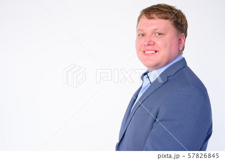 Closeup profile view of happy overweight businessman looking at camera Closeup profile view of happy overweight businessman looking at camera 57826845