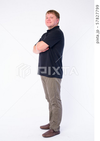 Full body shot profile view of happy overweight man looking at camera Full body shot profile view of happy overweight man looking at camera 57827799