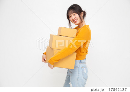 Happy Chinese Asian woman holding package parcel box 57842127