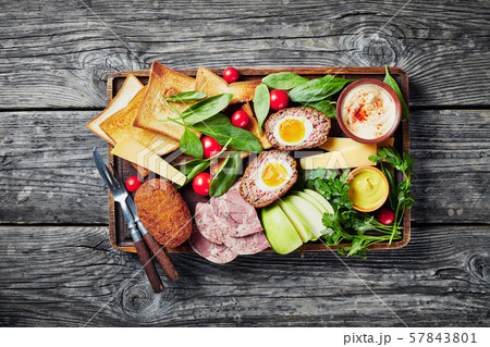 plowman's lunch on an old wooden tray 57843801
