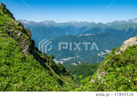 Valley with residential houses, surrounded by high mountains Valley with residential houses, surrounded by high mountains 57845516