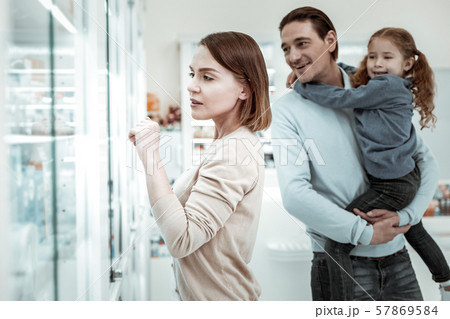 Loving mother choosing vitamins with her family in the drugstore Loving mother choosing vitamins with her family in the drugstore 57869584
