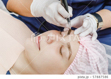 Permanent makeup, tattooing of eyebrows. Permanent makeup, tattooing of eyebrows. 57887586